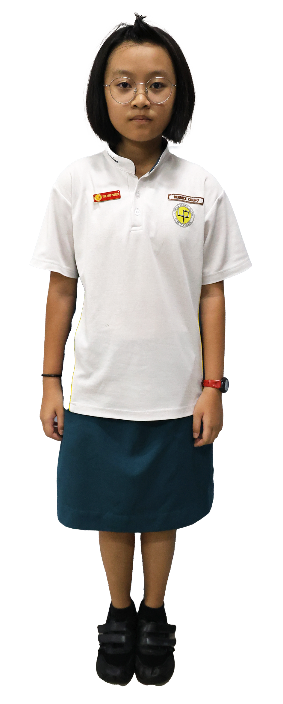 Young girl with short black hair and glasses wearing a white school polo shirt with badges and a teal skirt.